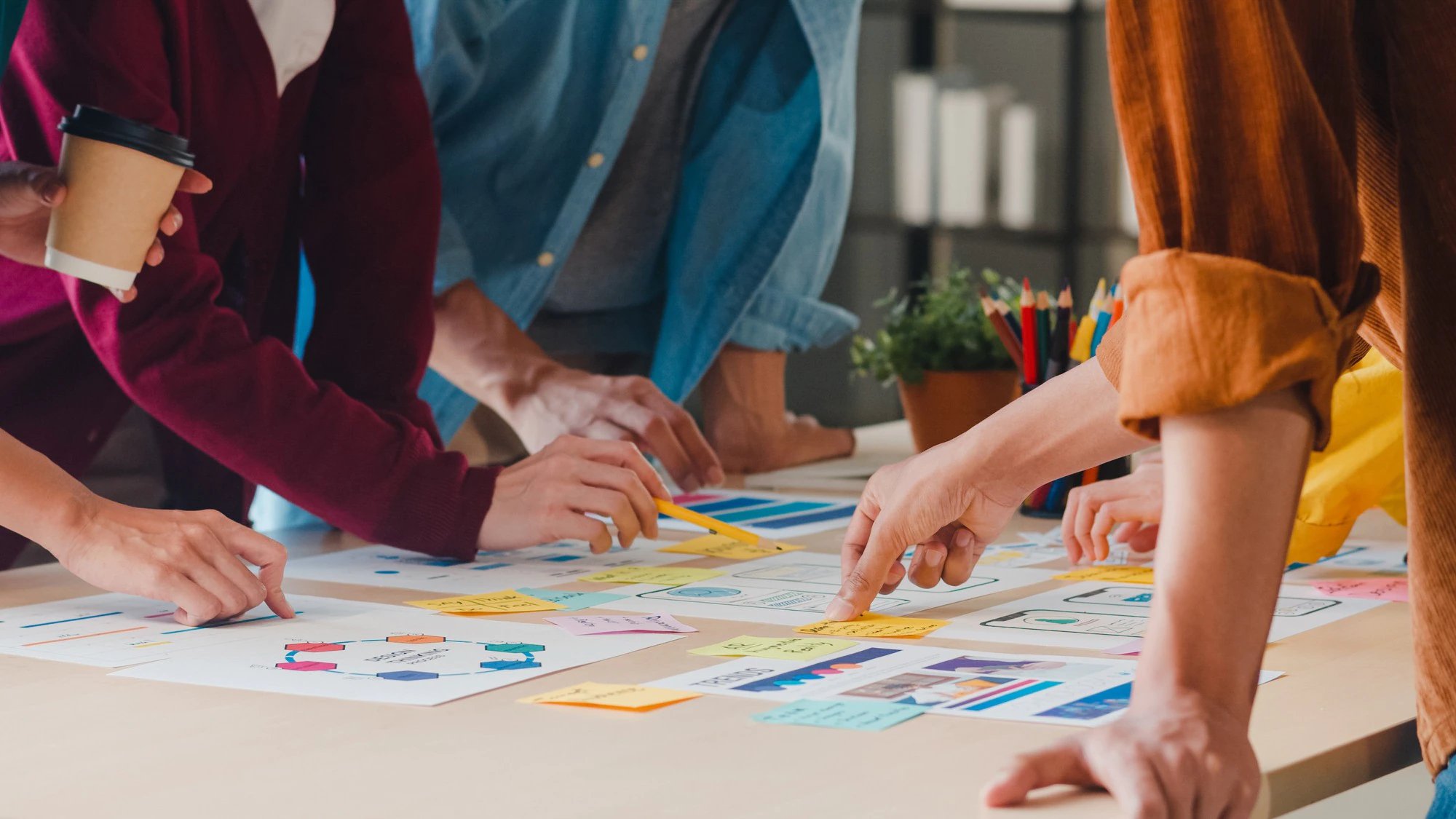 asian-businessmen-businesswomen-meeting-brainstorming-ideas-about-creative-web-design-planning-application-developing-template-layout-mobile-phone-project-working-together-small-office_7861-2682